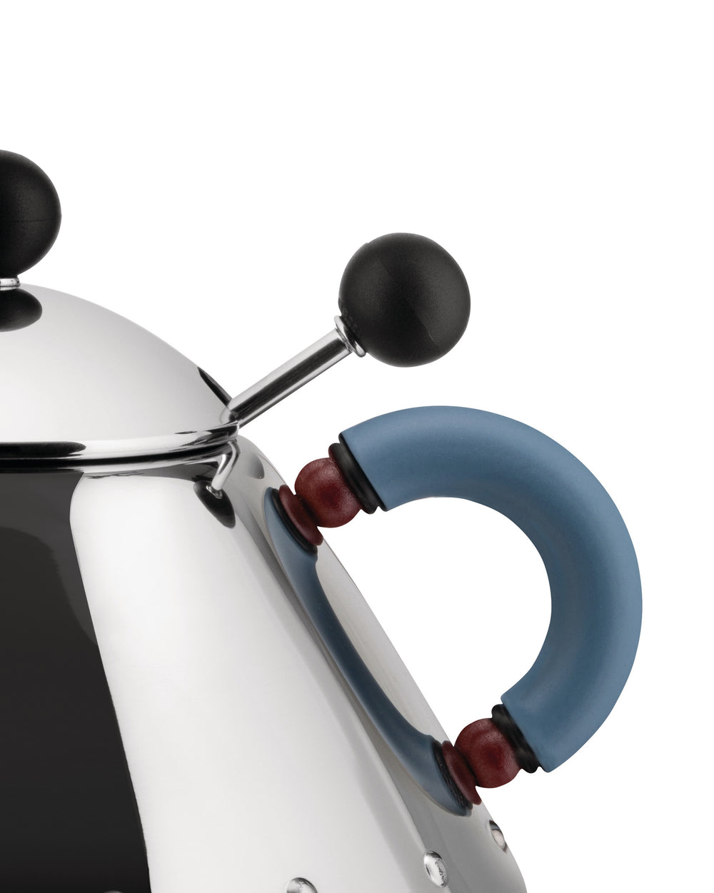 Chrome kettle by Alessi with a black whistle and a blue handle adorned with red beads, close-up.