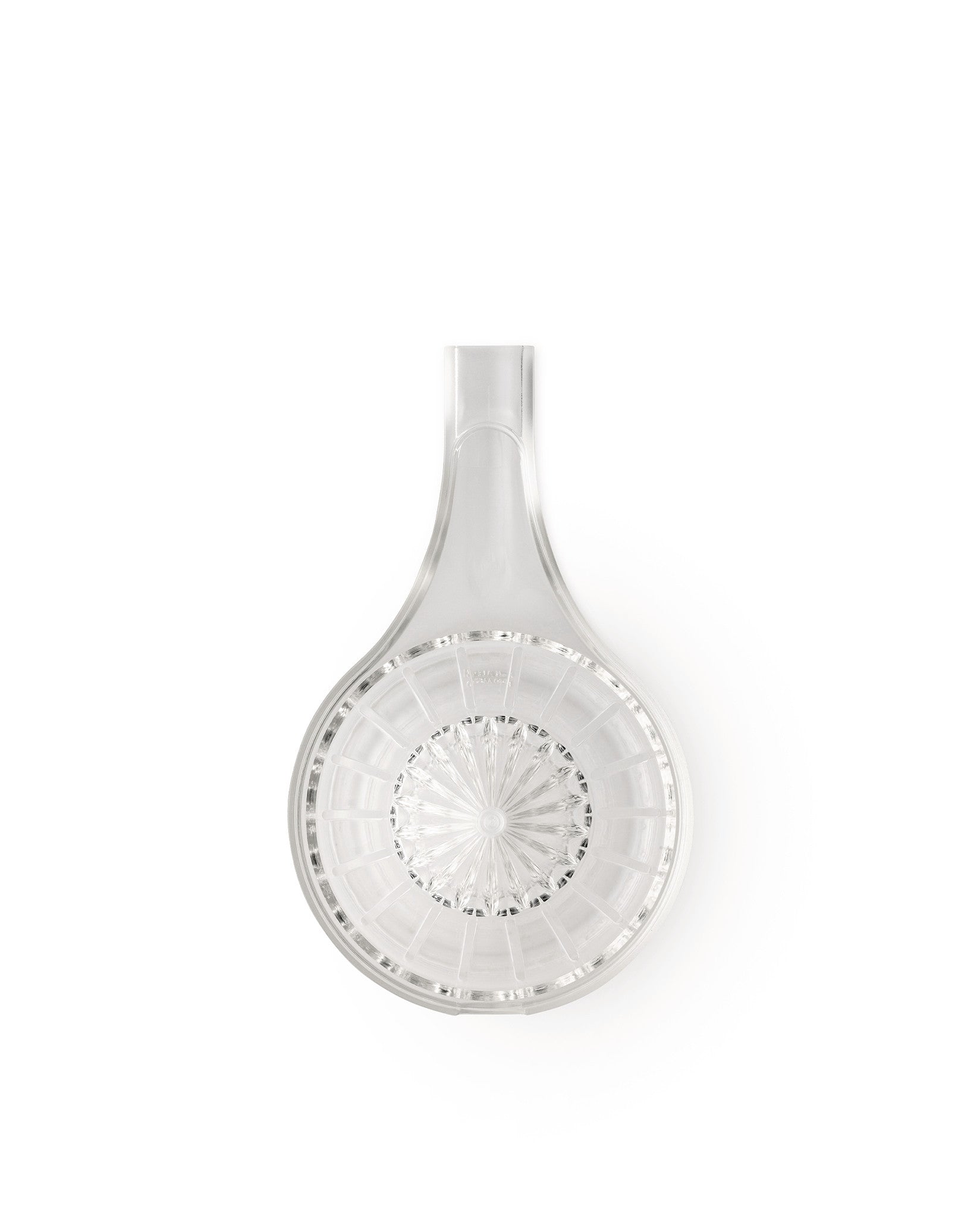 Clear glass citrus squeezer by Alessi, with a wide handle, central starburst pattern, and radial channels, viewed from above.