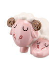 Glossy pink and white ceramic sleeping sheep figure by Alessi, with brown curled horns, black crescent eyes, and red P-shaped cheek marks.