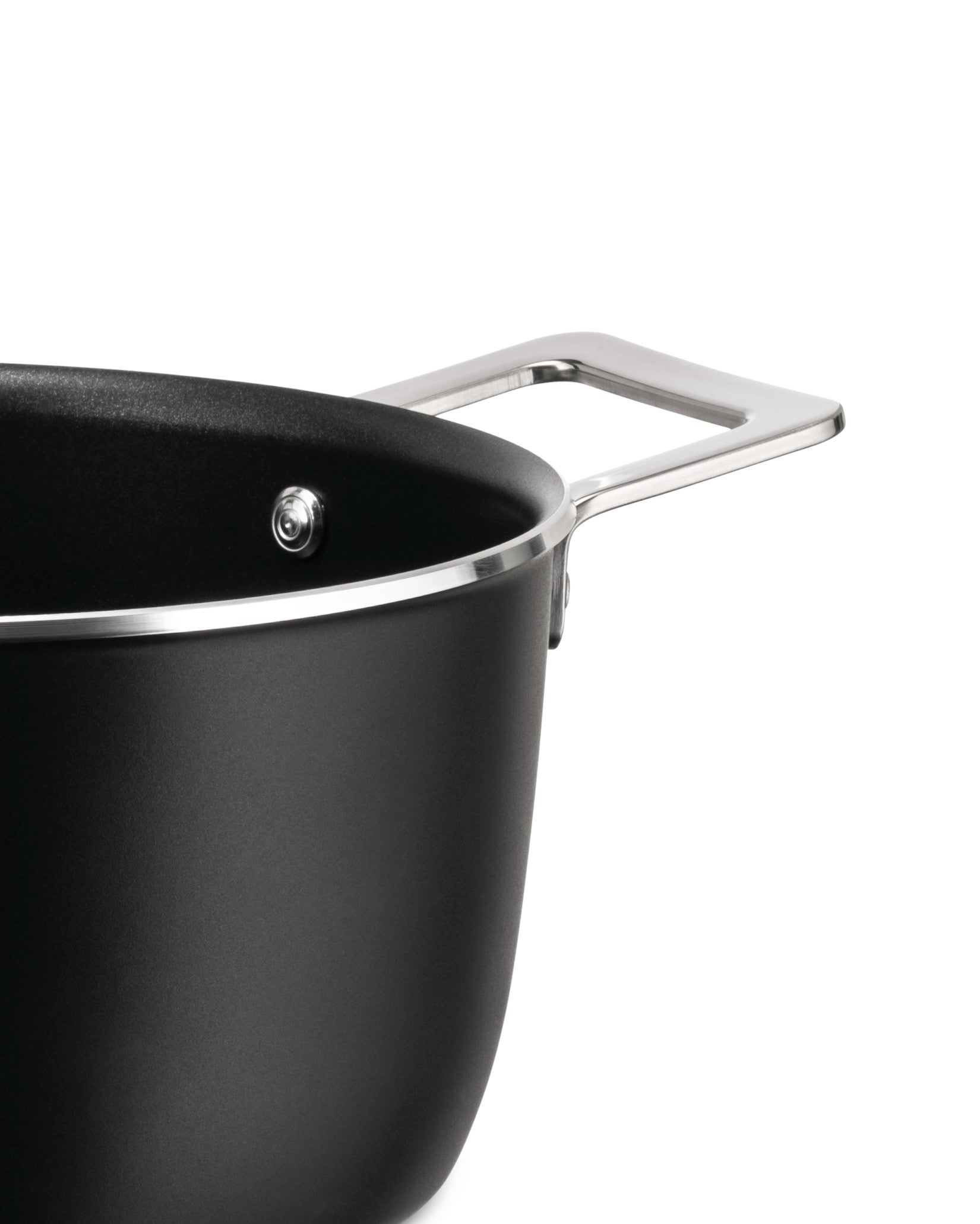 Matte black casserole pot by Alessi with a sleek silver handle and rim, cropped view.