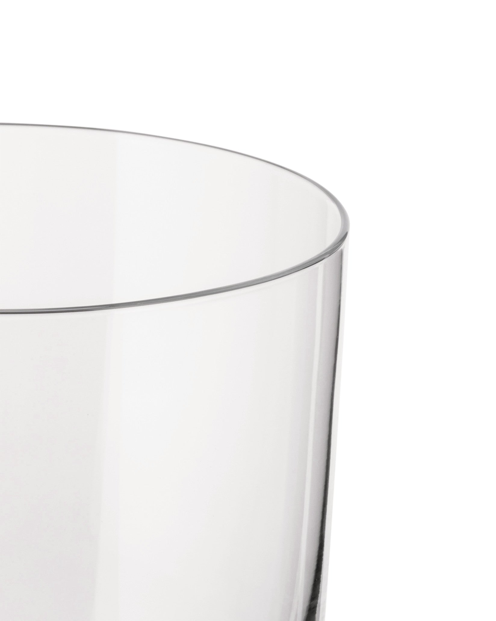 Clear glass by Alessi with a rounded rim, cropped side view.