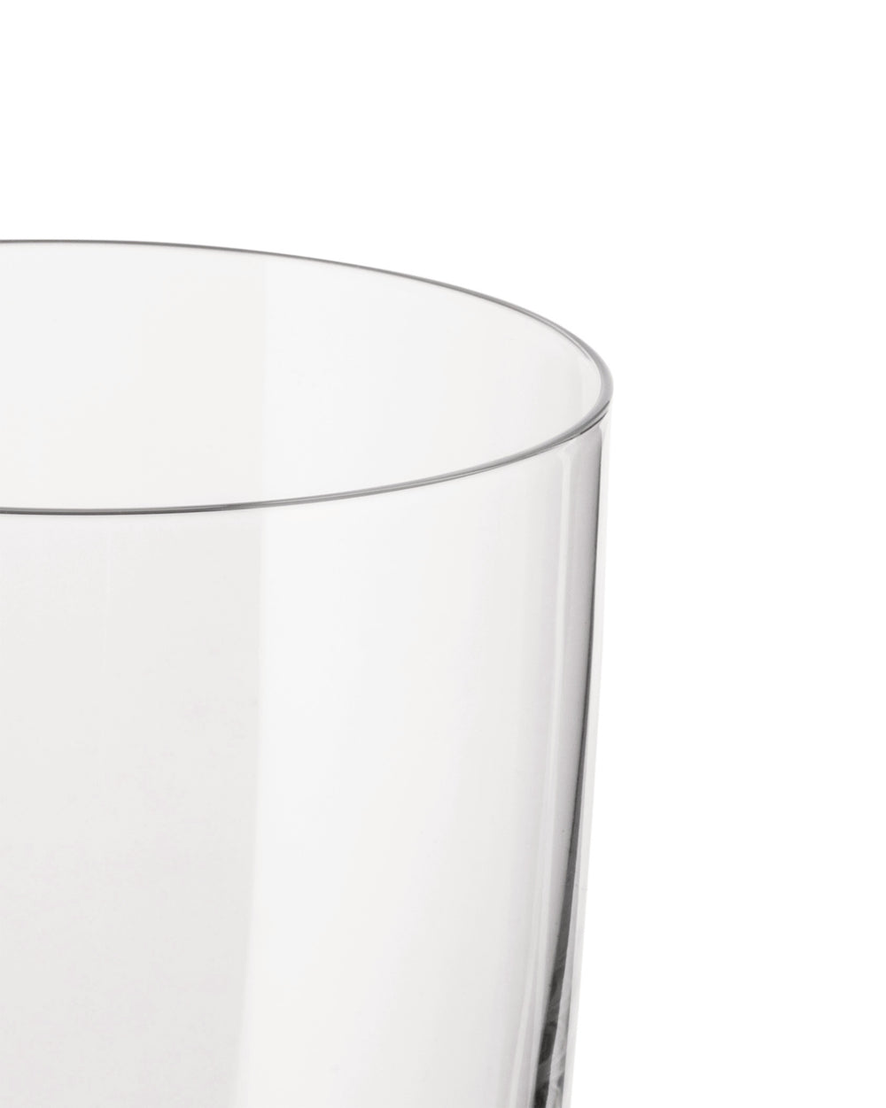 Clear drinking glass by Alessi, cropped close-up of its upper rim and side on a white background.