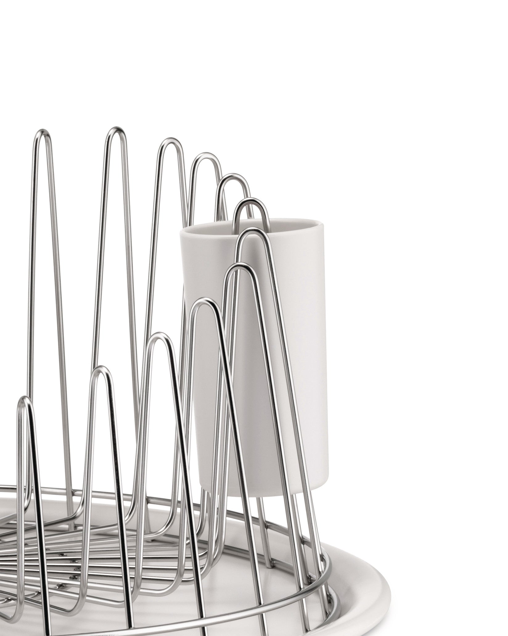Chrome-plated steel dish drainer by Alessi featuring wavy rods and a white base with a utensil holder.