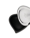Polished stainless steel heart-shaped container by Alessi, open to reveal a black textured interior.