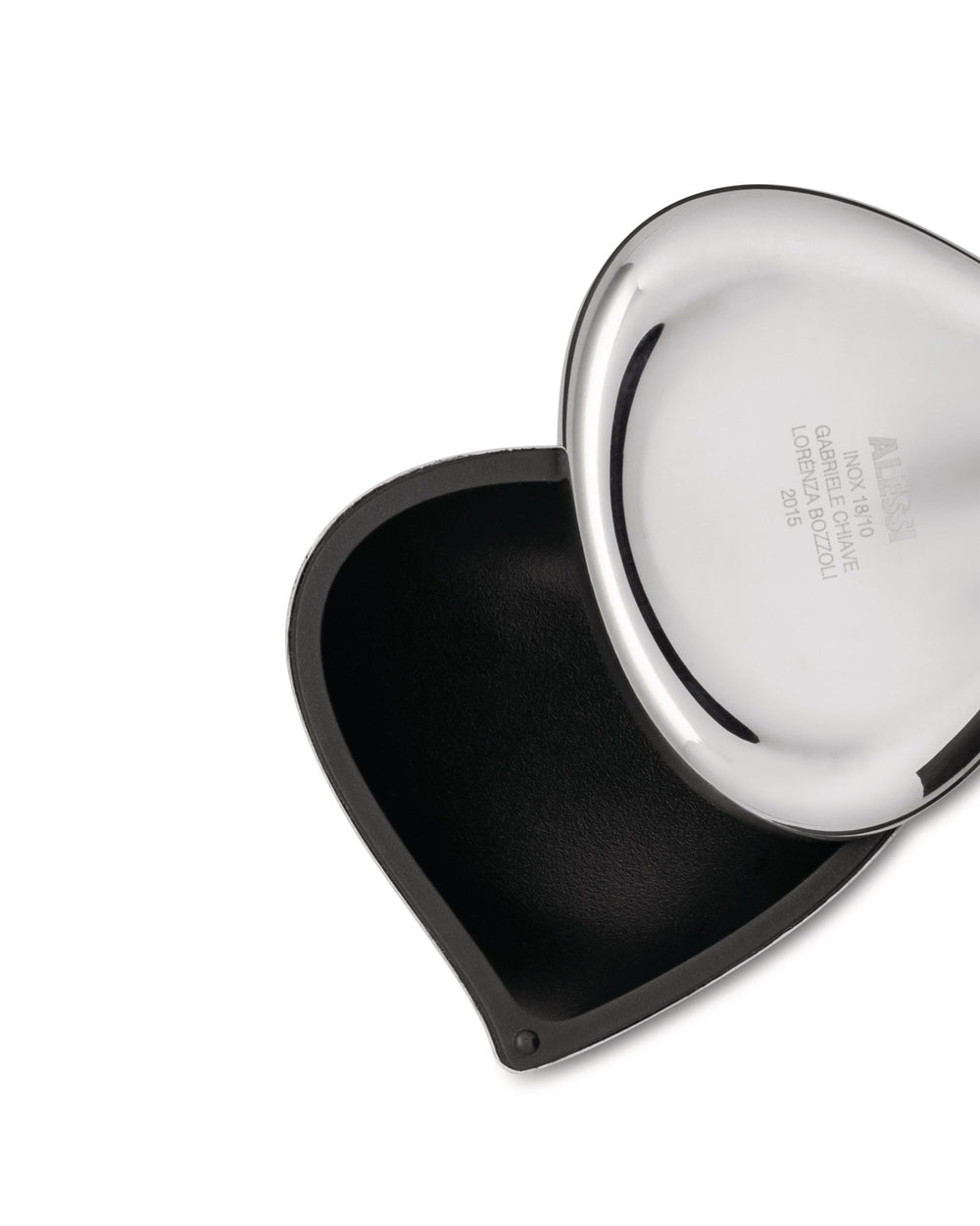 Polished stainless steel heart-shaped container by Alessi, open to reveal a black textured interior.