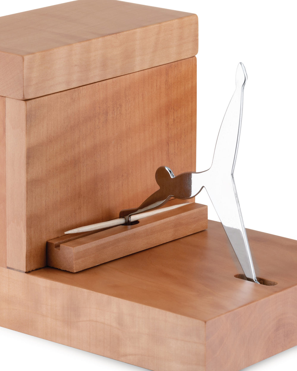 Light wood toothpick dispenser by Alessi, featuring a shiny silver bird-shaped mechanism on a rectangular base.