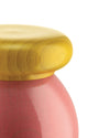 Golden lidded container with a pink base by Alessi, featuring a glossy finish and subtle concentric texture on the lid.