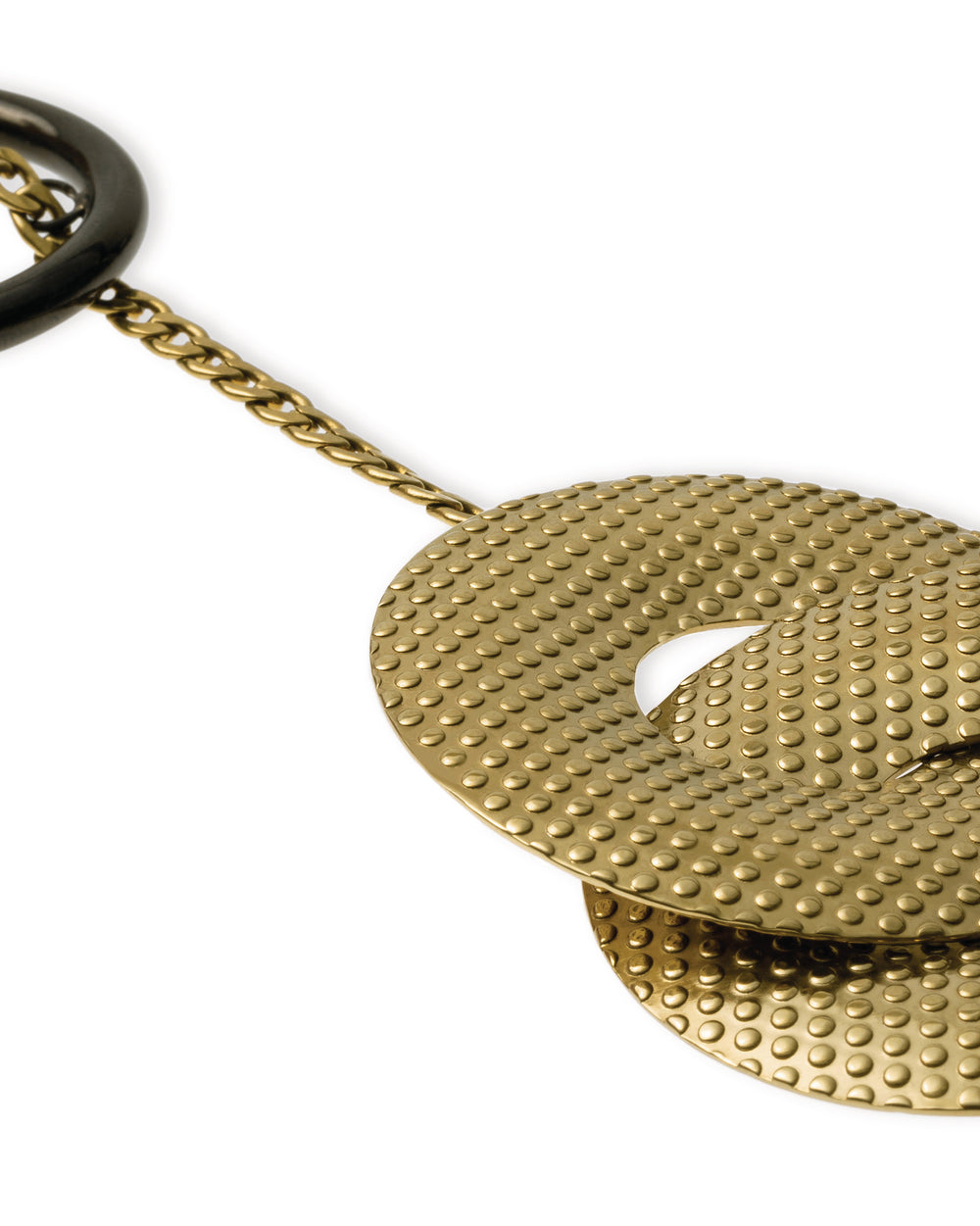 Gold-toned metal pendant by Alessi, with embossed dot-textured disks and a dark ring on a fine chain.
