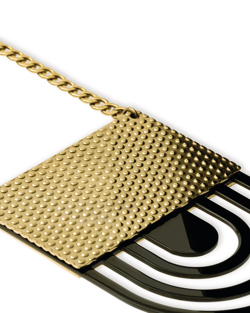 Gold-toned necklace by Alessi, featuring a geometric pendant with a textured gold top and black layered arch design.