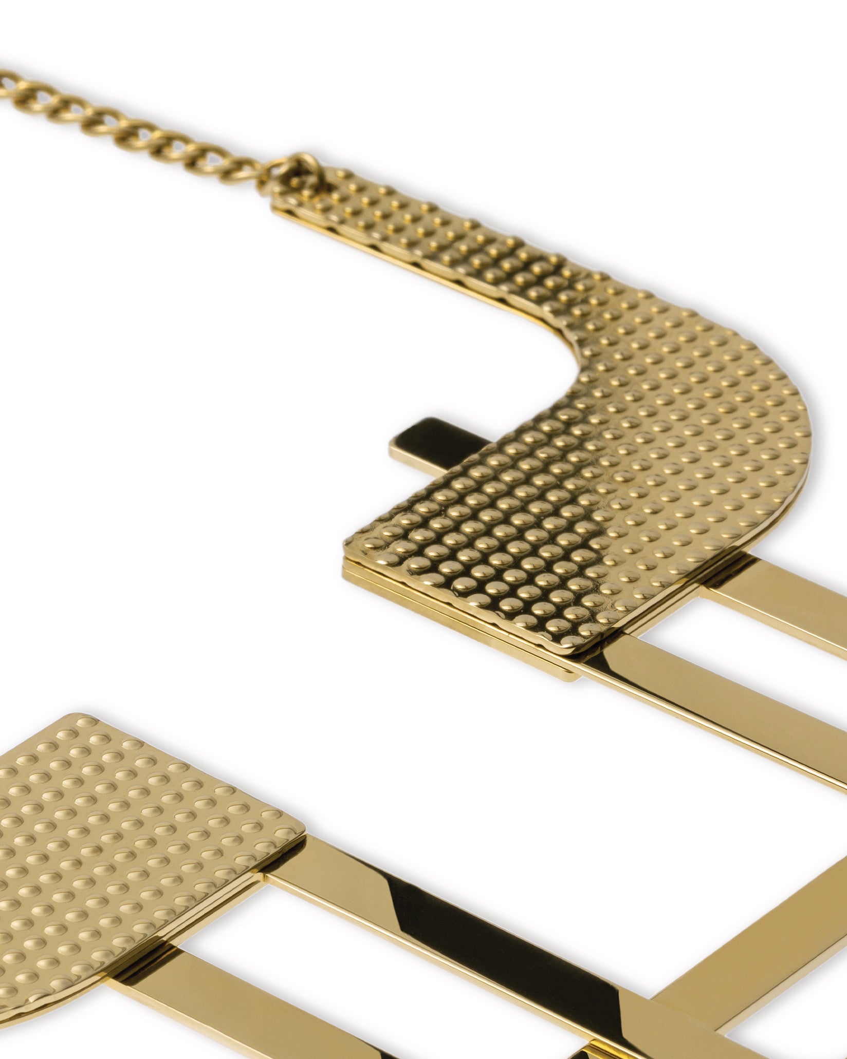 Gold metallic decorative bowl by Alessi, with hammered dimpled texture and a polished grid pattern.