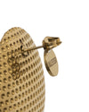 Gold-toned metal thimble by Alessi with dimpled texture and an engraved brand tag, close-up side view.