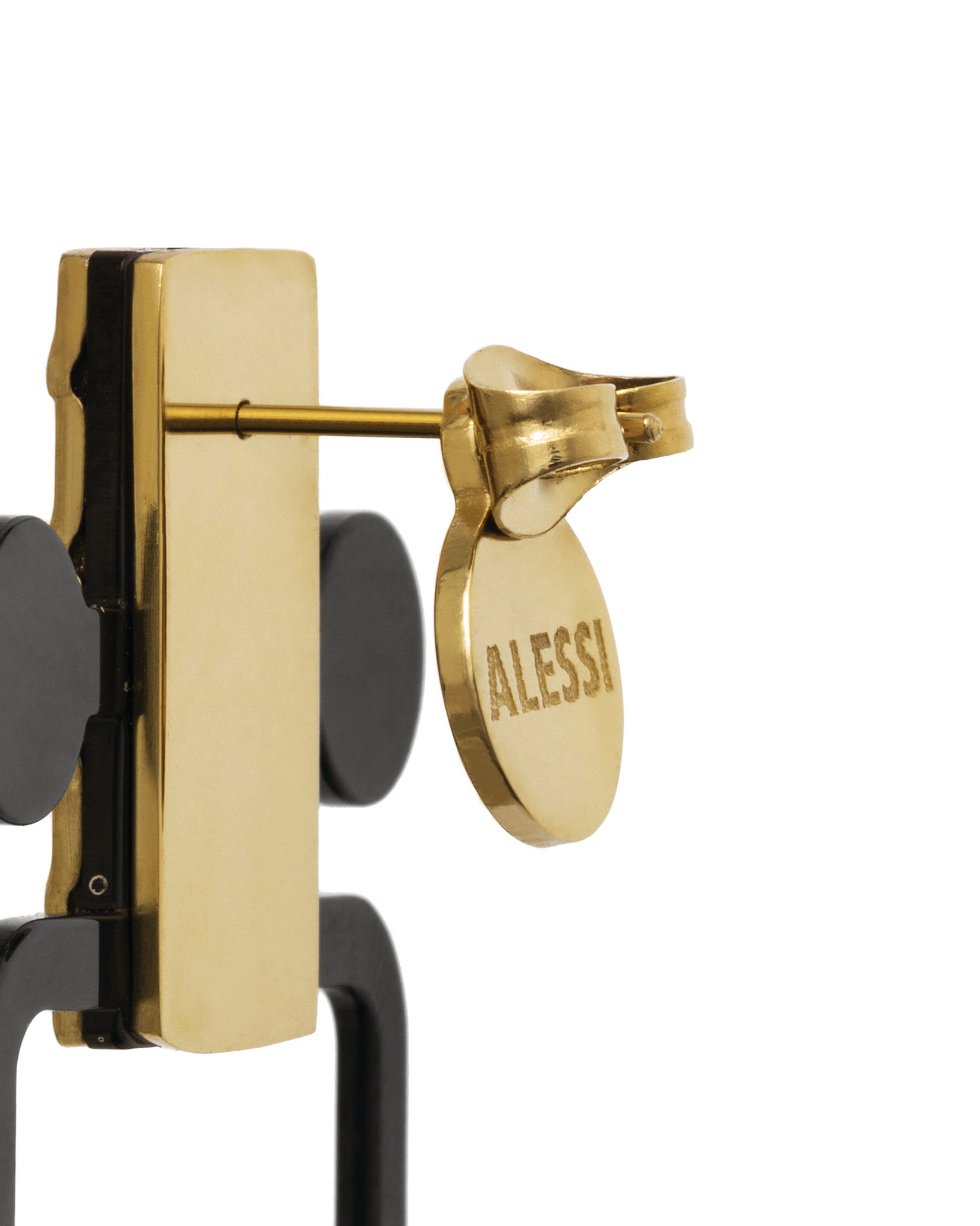Gold-toned metal key holder by Alessi, with an embossed oval tag.