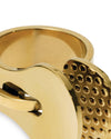 Gold-toned metal object by Alessi, detailed with a grid of small concave indentations in a close-up.