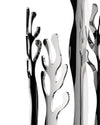 Polished silver-tone abstract sculptural decor by Alessi, featuring coral-like shapes and strong reflections against a white background.