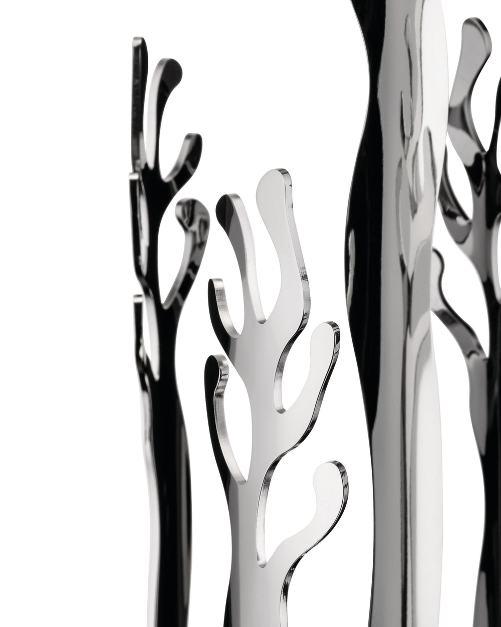 Polished silver-tone abstract sculptural decor by Alessi, featuring coral-like shapes and strong reflections against a white background.