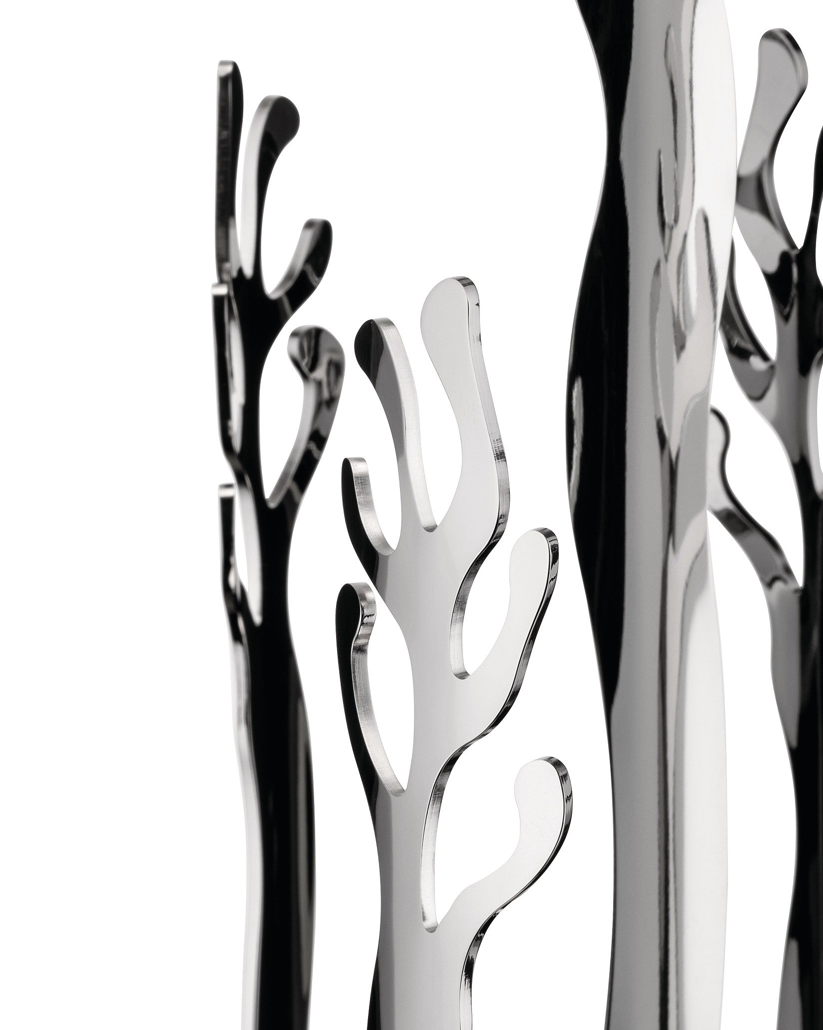 Polished silver-tone abstract sculptural decor by Alessi, featuring coral-like shapes and strong reflections against a white background.