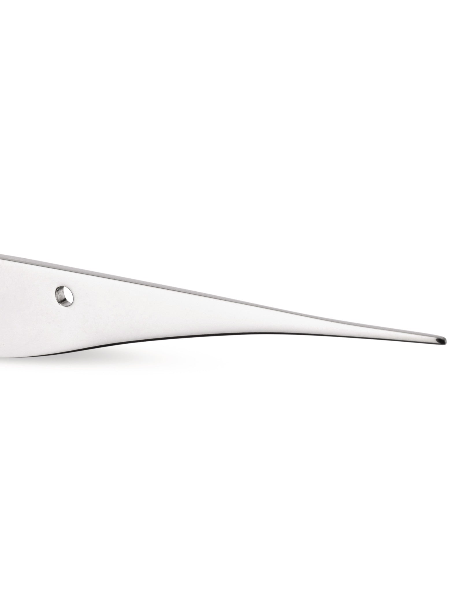 Silver-toned, flat, tapered metal utensil by Alessi featuring a small circular hole, cropped side view.