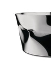 A silver sculptural bowl by Alessi, with a highly reflective, crumpled metal surface showing abstract black and white forms.