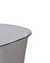 Translucent grey container by Alessi, with a smooth finish and curved dark rim, cropped view.