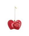 Glossy red heart-shaped ornament by Alessi, embellished with red gems and a smiling heart, hanging from a gold chain.