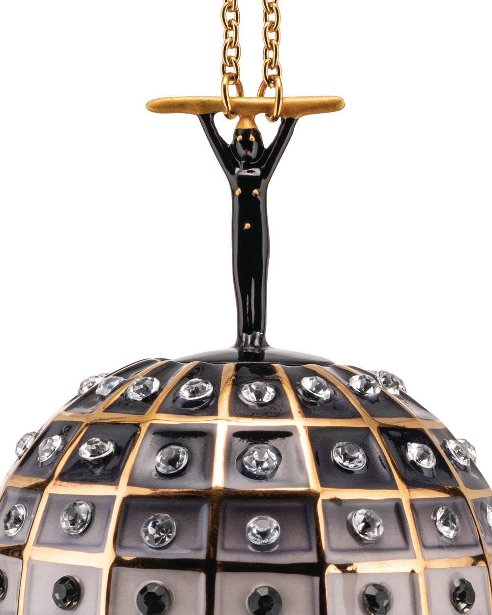 Black and gold hanging ornament by Alessi, featuring a stylized figure holding a bar above a diamond-studded grid sphere.
