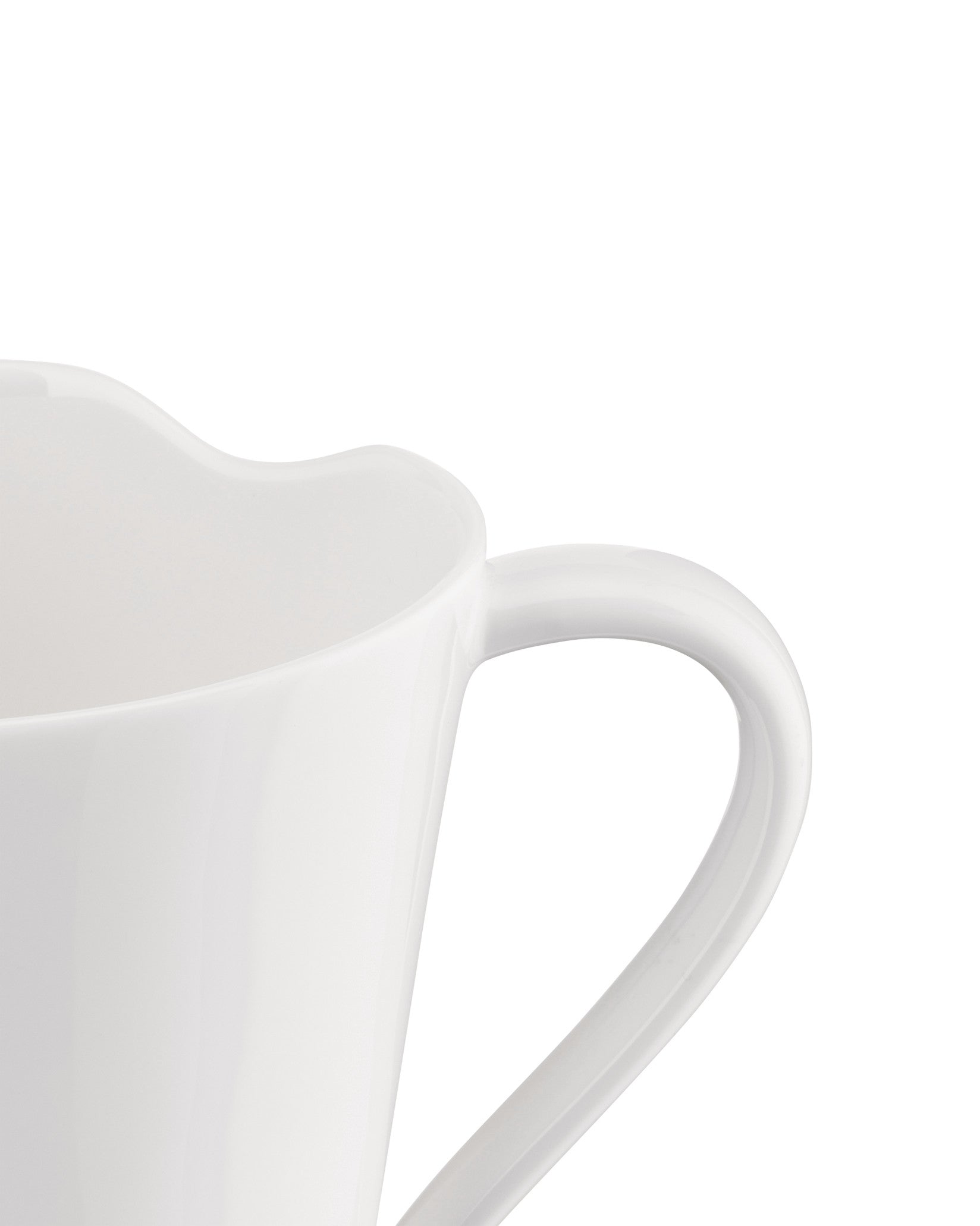 White ceramic cup by Alessi with a distinctive wavy rim and elegant handle, close-up.