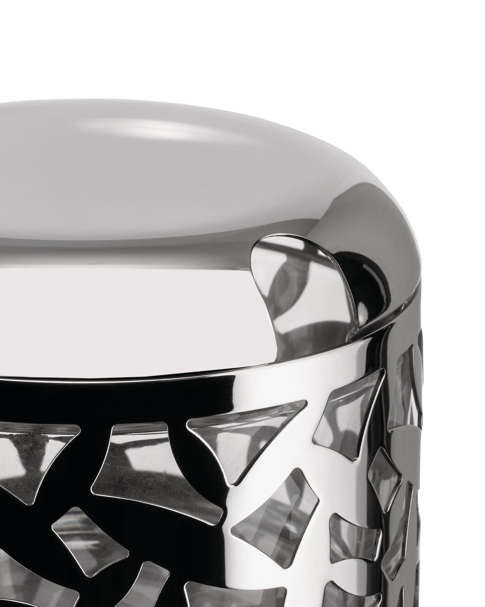 Polished silver metal cheese cellar by Alessi, featuring a geometric cut-out pattern on the side in a close-up.