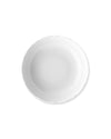 White glossy plate by Alessi with a wavy, irregular edge, seen from above.