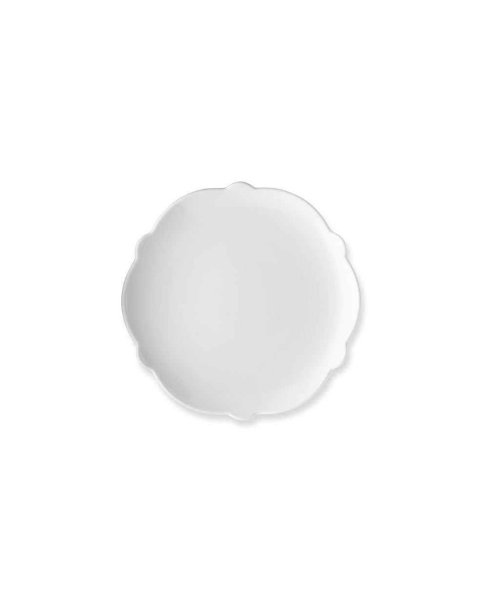 White scalloped-edge plate by Alessi, plain and circular, viewed from above.