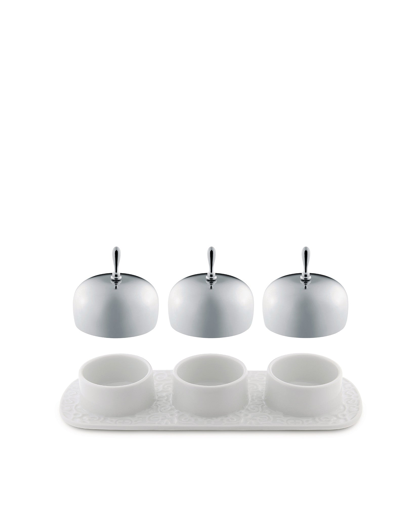 White porcelain condiment serving set by Alessi with a patterned tray and three domed chrome lids.