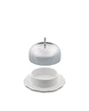White ceramic butter dish by Alessi with a shiny domed silver lid floating above an ornate embossed base.
