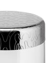 Silver and white container by Alessi with embossed organic patterns on its metallic lid and upper body.