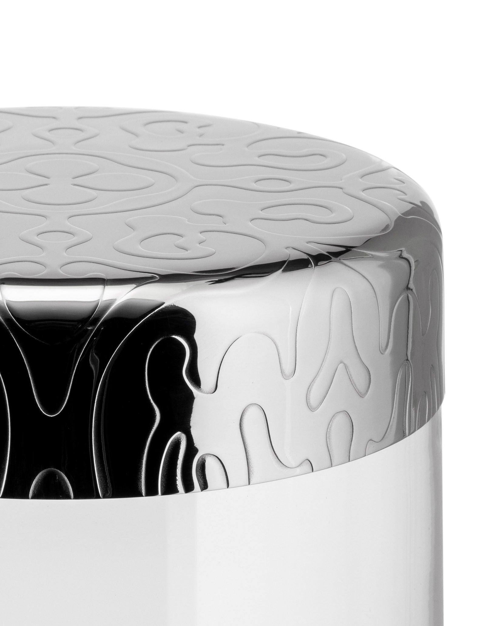 Silver and white container by Alessi with embossed organic patterns on its metallic lid and upper body.