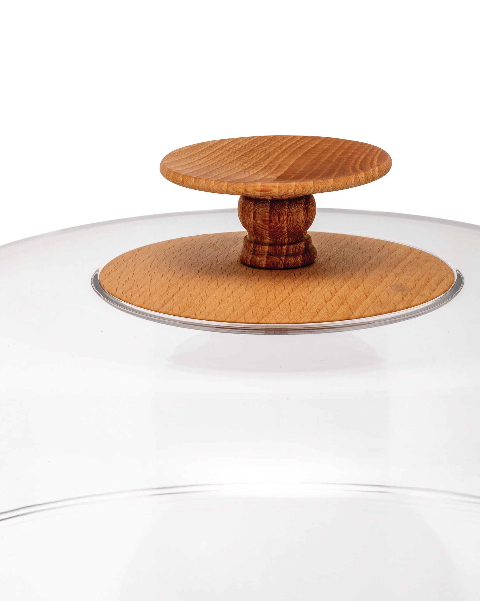 Clear glass lid with a natural wood knob handle by Alessi, showing concentric circles and wood grain.