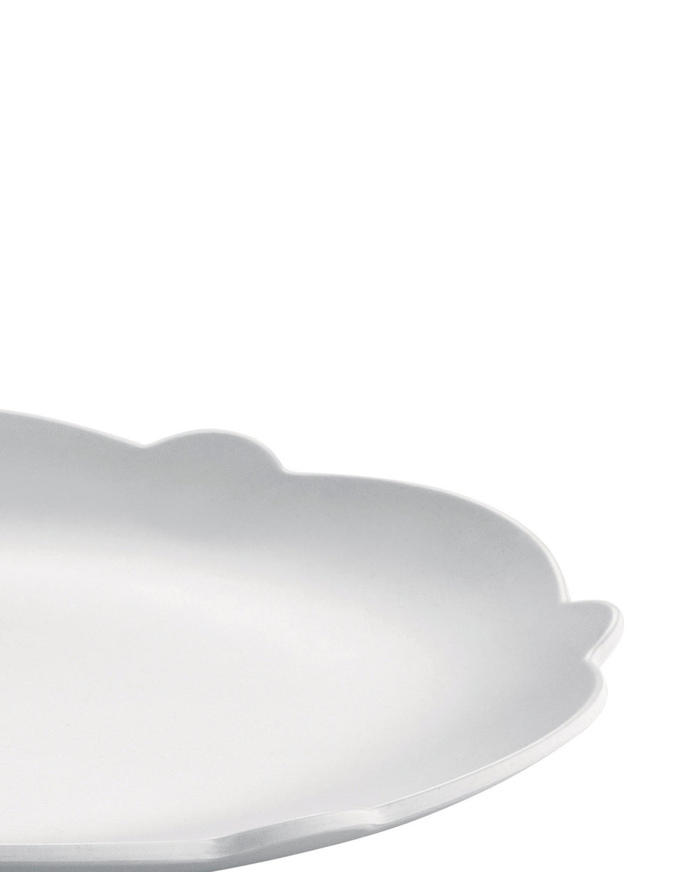 White scalloped serving platter by Alessi, with a matte finish, in a cropped, angled view.
