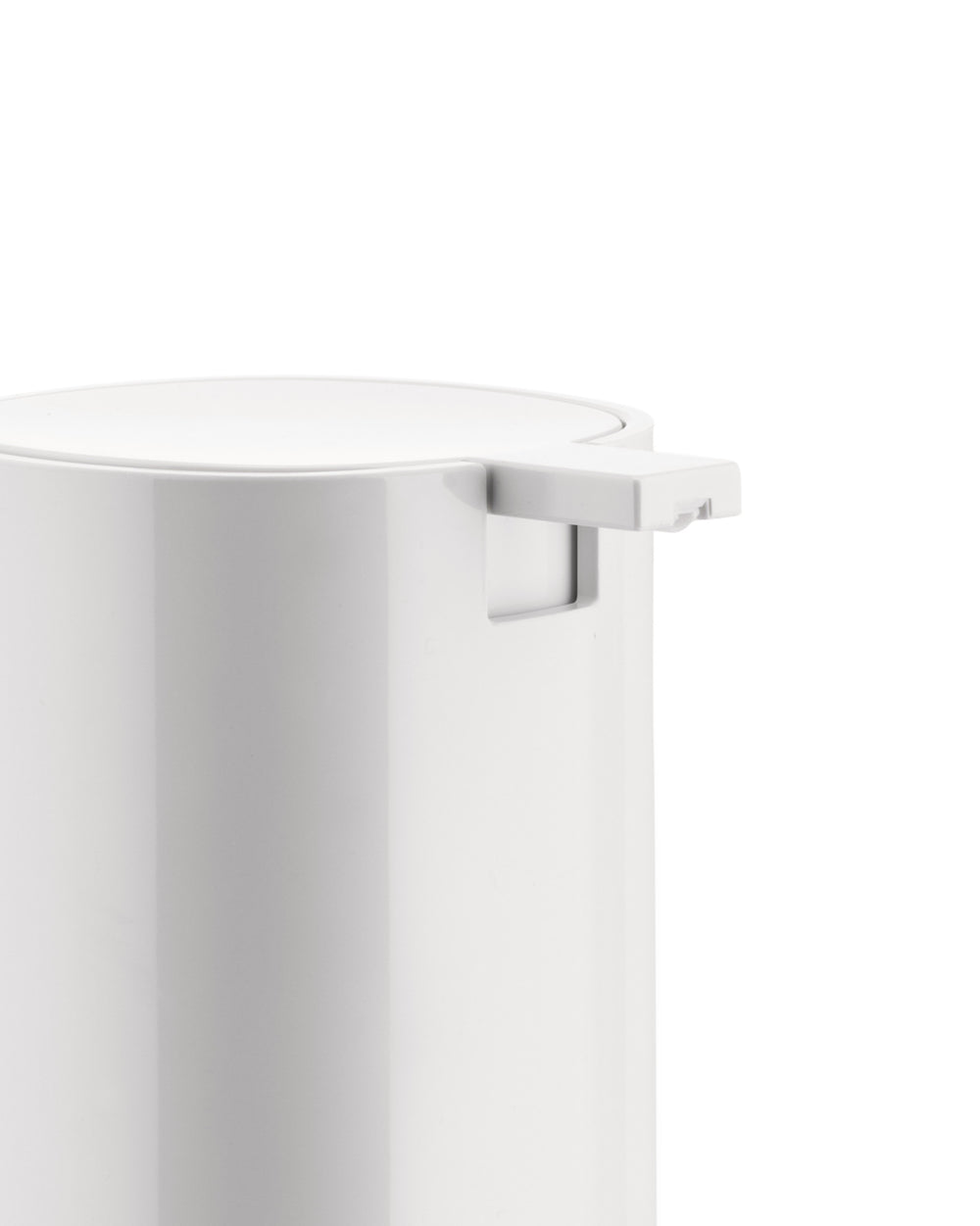 White cylindrical dispenser by Alessi, cropped close-up showing the smooth top and pump mechanism.