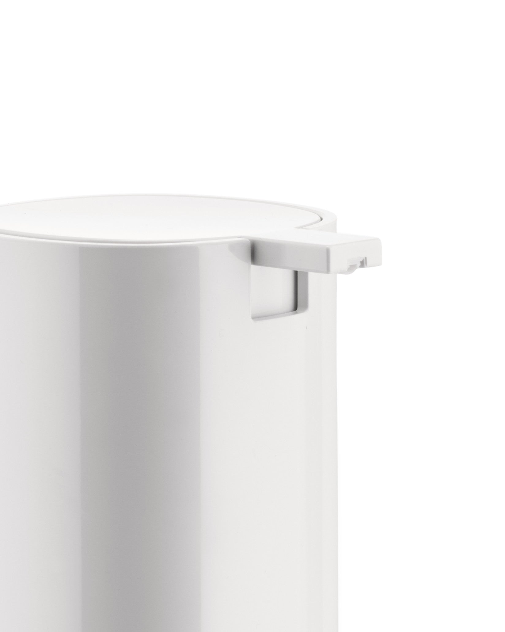 White cylindrical dispenser by Alessi, cropped close-up showing the smooth top and pump mechanism.