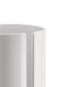 White cylindrical holder by Alessi with a vertical slot, showing a smooth, glossy finish.