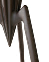 Dark bronze-colored sculptural lemon squeezer by Alessi, with a textured metallic finish and embossed brand details on a leg, cropped view.