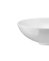 White bowl by Alessi with a smooth, glossy surface, in a cropped side view.