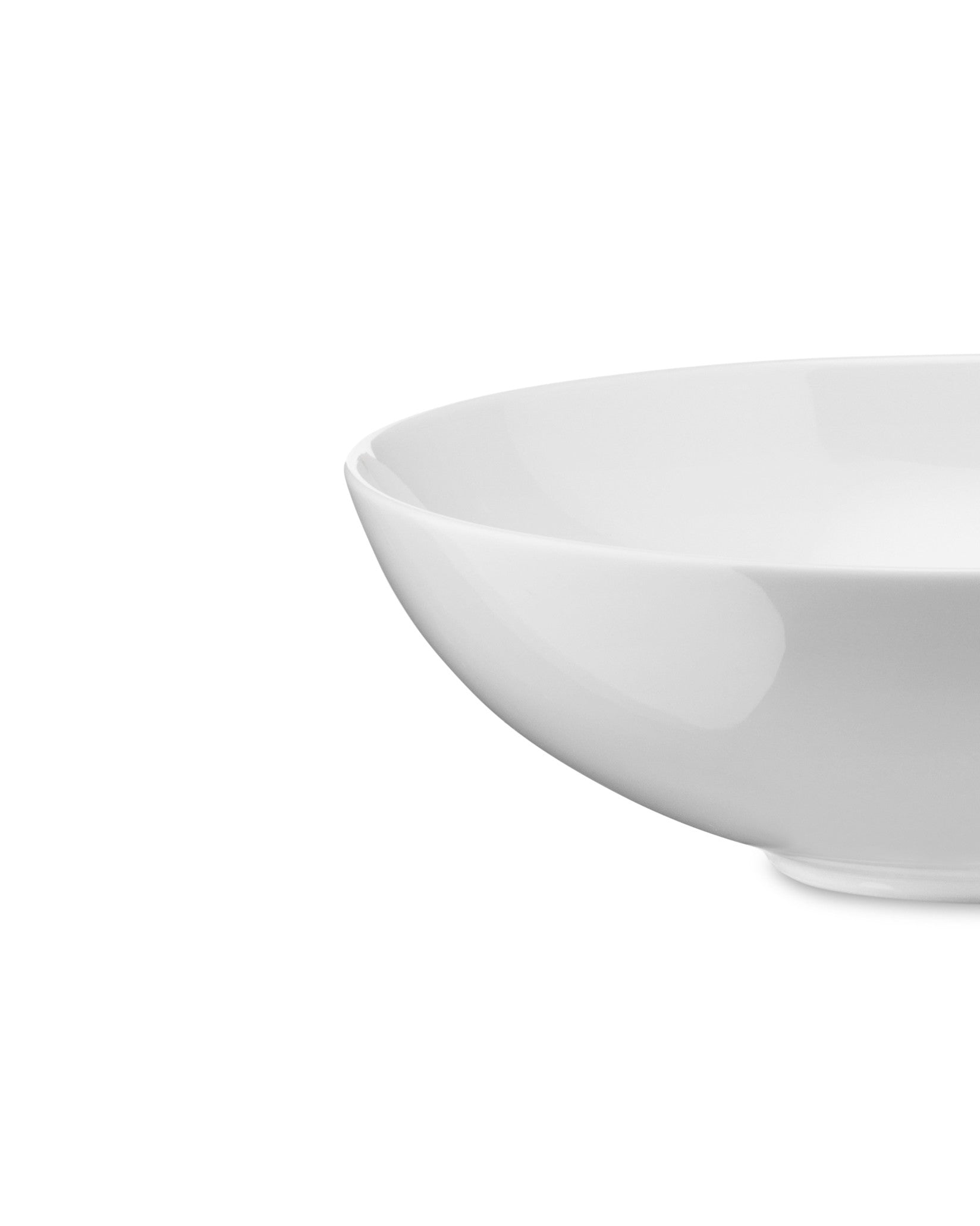 White bowl by Alessi with a smooth, glossy surface, in a cropped side view.