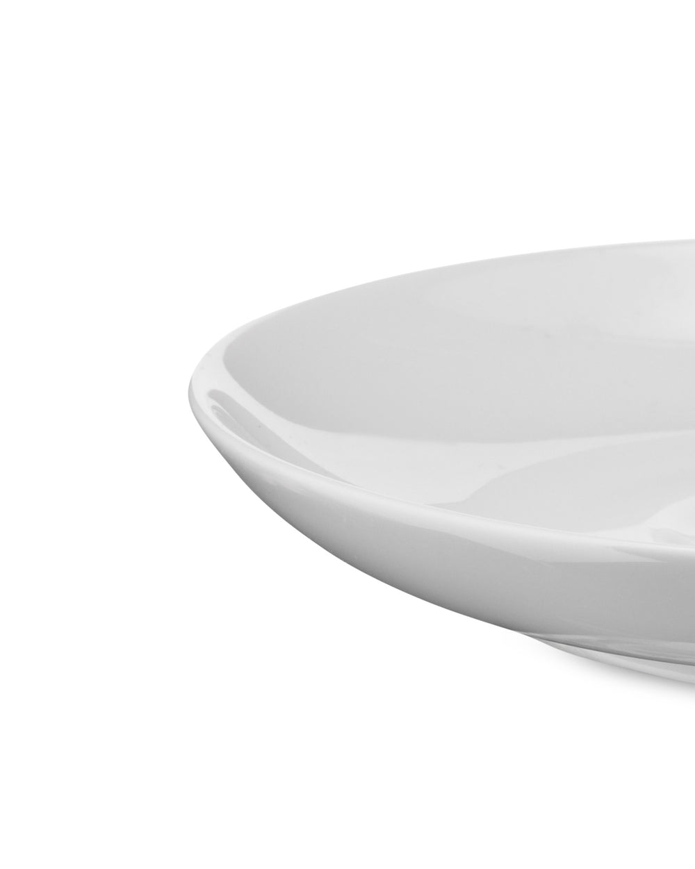 White Mami plate by Alessi, a close-up, cropped side view showing its glossy finish and gently curved edge.