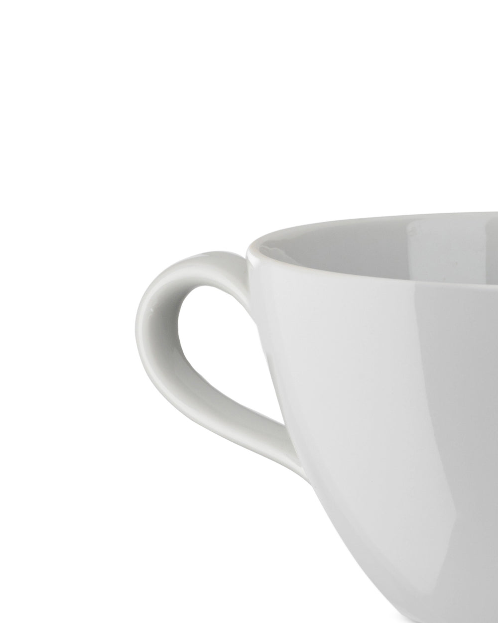 White ceramic cup by Alessi, visible from the side with a prominent curved handle.