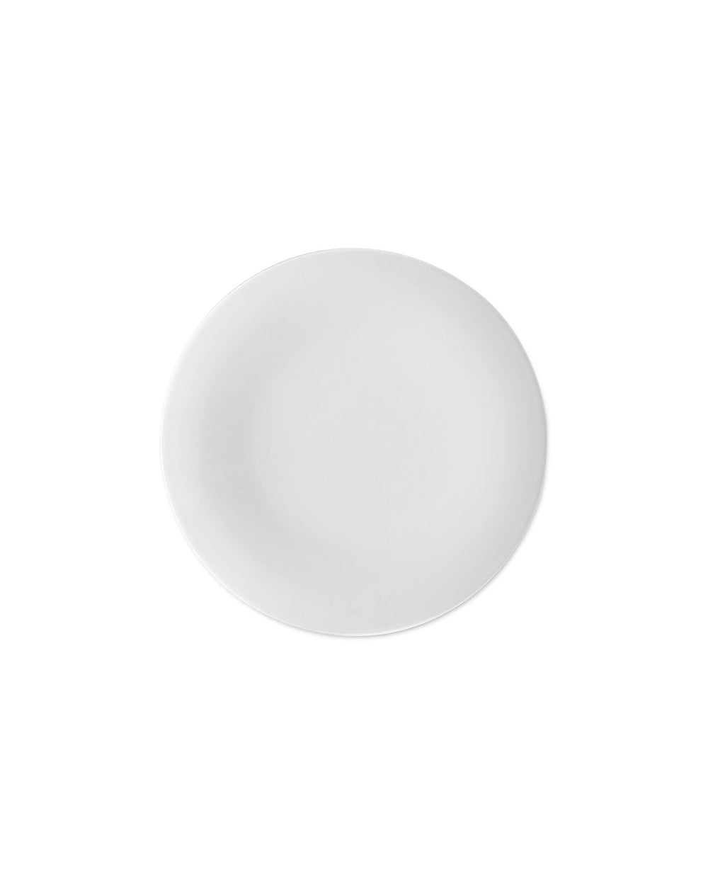 White round plate by Alessi, minimalist design with a matte finish from a top-down view.