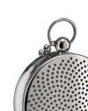 Silver metal T-Timepiece by Alessi, featuring a perforated disc and attached ring and chain, in a close-up.