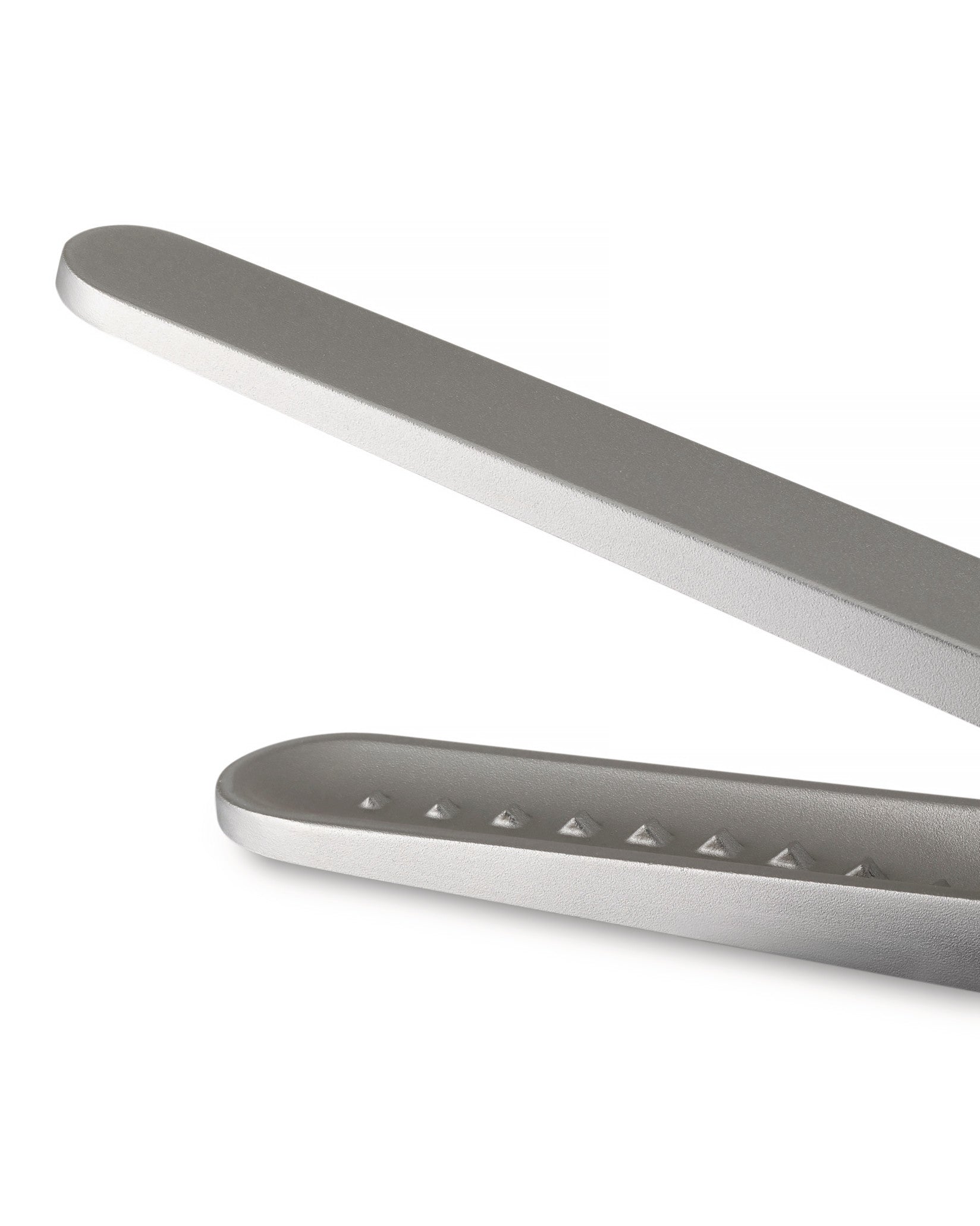 Silver metallic sugar tongs by Alessi, cropped, showing a textured jaw with raised pyramid dots.