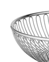 Silver metal fruit basket by Alessi with a polished top rim and curved wire design, shown cropped.