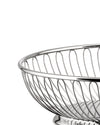 Silver metal wire bowl by Alessi with an elegant looped design, close-up.