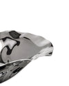 Wavy metallic silver bowl by Alessi with a highly reflective surface and organic, fluid shape, cropped view.
