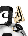 Silver whistling kettle by Alessi with a black handle and a golden whistle lifted from the spout.